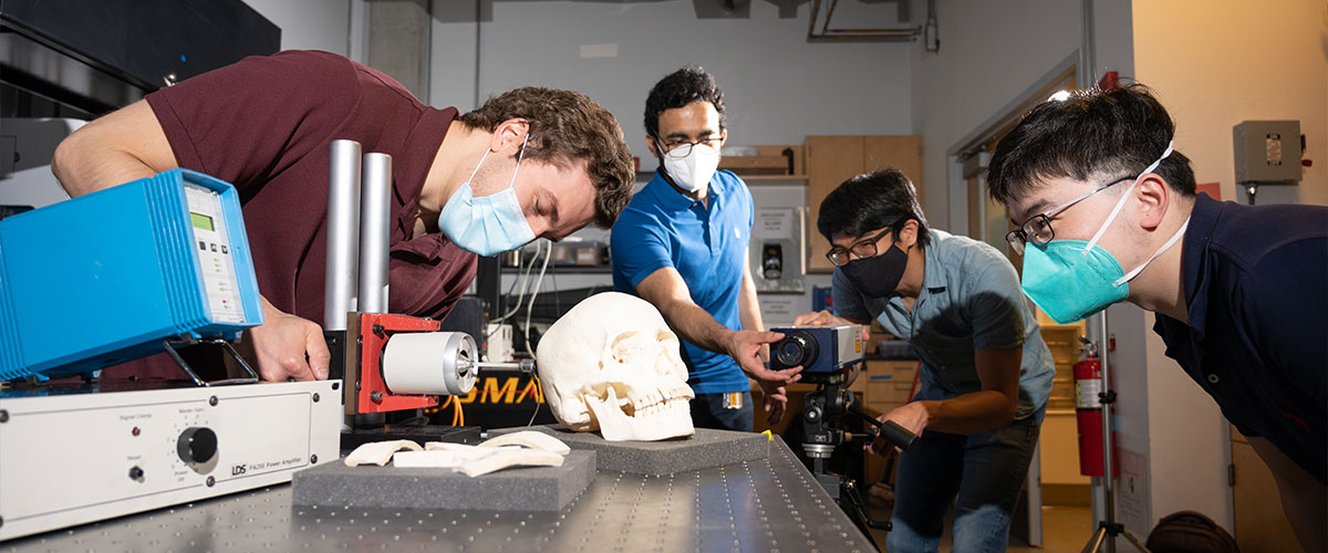 Graduate research assistants test a human skull