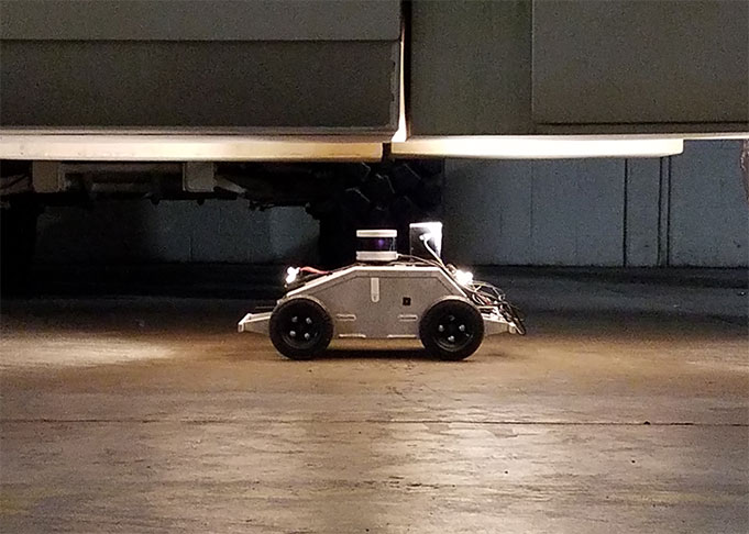 ARTI robot taking pictures of a vehicle undercarriage.